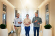© peopleimages.com - Smile, coffee break and business people in hallway for work culture, planning and collaboration or teamwork. Happy talking, workplace and group of women and man in discussion or job conversation