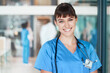 © peopleimages.com - Portrait, happy woman and proud nurse in clinic for healthcare services, career and medicine. Face, medical professional or confident female surgeon with smile at wellness hospital ready for nursing