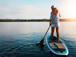 © ReeseArcurs/peopleimages.com - Back, woman and lake for paddleboard on holiday with adventure, recreation and fun in Bali. Female person, explore and travel for summer vacation, journey and break to relax with fitness activity