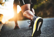 © ClearConcept/peopleimages.com - Person, legs and running start with shoes in street for morning workout, race or outdoor exercise. Closeup of active athlete, runner or sprinter ready for fitness, cardio or challenge on asphalt road