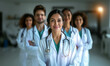 © Viktoryia Labanava - medical staff, a woman doctor smiles, doctors stand behind her, a team of doctors in the hospital