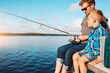 © ReeseArcurs/peopleimages.com - Lake, father and son together for fishing lesson with holiday bonding, knowledge and teaching skill. Dad, child and learning tips to catch fish by river with rod, travel and vacation peace in Florida