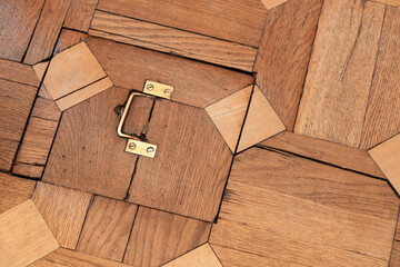 Wall Mural - Closed hatch with brass handle is in vintage wooden parquet f