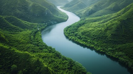 Wall Mural -  A bird's-eye perspective of a winding river set in a verdant valley, encircled by towering mountains A solitary figure, situated at the river'