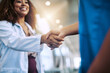 © ClearConcept/peopleimages.com - Woman, handshake and medical in hospital for partnership with nurse, introduction and onboarding meeting success. Doctor, people and agreement, support and promotion for clinic welcome achievement
