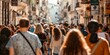 © inspiretta - A busy street with a large crowd of people walking down it. Scene is lively and bustling