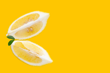 Wall Mural - Fresh lemon slices on yellow background.