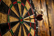 © barmaleeva - Dart hitting the bullseye on a dartboard. Business target or goal success, winner concept