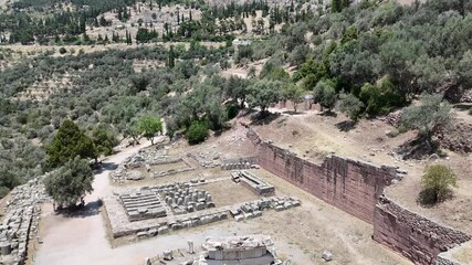 Wall Mural - Aerial bird's eye view video taken by drone of archaeological site of ancient Delphi, site of temple of Apollo and the Oracle, Voiotia, Greece