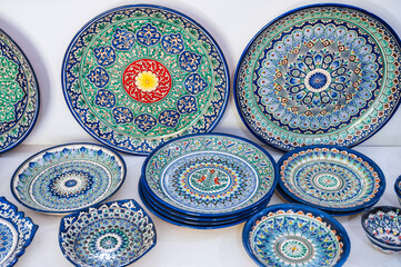 Wall Mural - Arabic Uzbek handmade ceramic plates with hand-painted with a traditional East Asian colorful pattern in bazaar in Uzbekistan in Tashkent