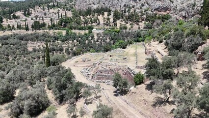 Wall Mural - Aerial bird's eye view video taken by drone of archaeological site of ancient Delphi, site of temple of Apollo and the Oracle, Voiotia, Greece