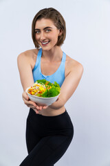 Wall Mural - Full body length gaiety shot athletic and sporty young woman with healthy vegan food in standing posture on isolated background. Healthy active and body care by vegetarian lifestyle.