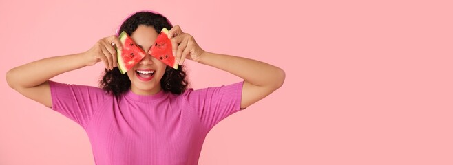 Poster - Funny young African-American woman with slices of fresh watermelon on pink background with space for text