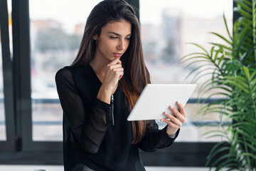 Wall Mural - Smart freelance business woman seller working with digital tablet in her startup small business.