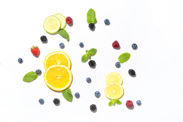 Wall Mural - Fresh fruits, mint and berries for tasty lemonade on white background