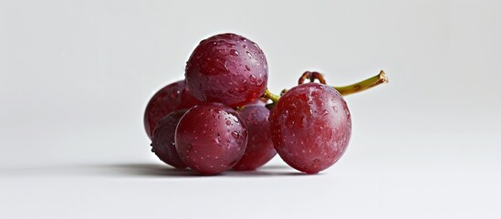 Wall Mural - Focused on a singular red grape against a white background with plenty of copy space in the image.