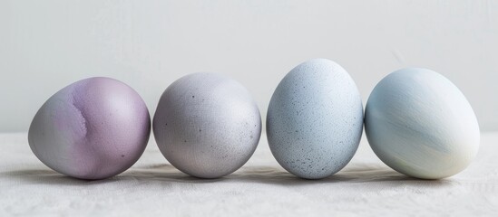 Wall Mural - Stylish Easter eggs in shades of gray, violet, and blue, featuring natural dye; ideal for a copy space image.