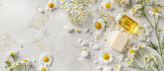 Sticker - Chamomile spa arrangement featuring chamomile flowers, handmade soap, essential oil bottle, body cream, scrub, sea salt on white textured background with copy space image for beauty treatments.