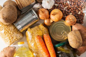 food storage and eating concept - close up of different cereals, groceries and preserves, top view