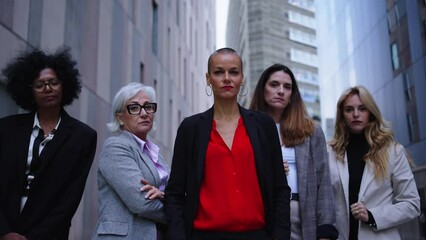 Wall Mural - Portrait of multiracial and diverse ages business women in formal suits posing serious with arms crossed looking at camera. Empowered and successful female entrepreneurs happy and powerful outdoor