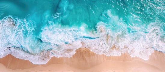 Wall Mural - Capturing a stunning aerial image of a pristine tropical beach with foamy waves and crystal-clear waters, a perfect backdrop for summer vacation, featuring ample copy space.