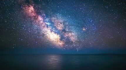 Wall Mural - A beautiful night sky with a large, colorful nebula in the middle. The sky is filled with stars and the water is calm