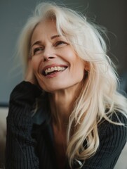 Wall Mural - A happy woman with blonde hair is smiling while wearing a black sweater