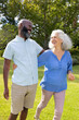 © WavebreakMediaMicro - Walking outdoors, man and senior woman smiling and enjoying conversation