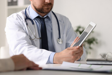 Poster - Professional doctor working with patient at white table in hospital, closeup