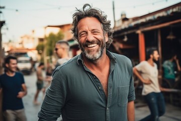 Wall Mural - Handsome middle aged man smiling at the camera while walking in a busy street.