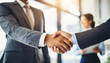 © Your Hand Please - blurred office background with a close-up of a business handshake, symbolizing trust, agreement, and collaboration between business professionals