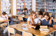 © JackF - Teenage students working in groups in college library