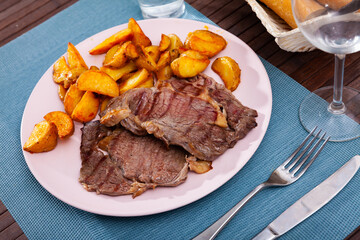 Wall Mural - Delicious grilled beef with baked potatoes served at the plate