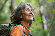 © anzodesign - Joyful woman hiking through green forest on a sunny day