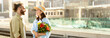 © Prostock-studio - Positive young caucasian husband meets surprised lady, gives bouquet of flowers on train station. Love, relationship, travel lifestyle, dating romance, vacation and come back, copy space
