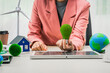 © NanSan - Female entrepreneur working at desk in clean energy sector Focusing on wind turbines solar energy Renewable energy Sustainable development goals House that uses solar energy and electric vehicles