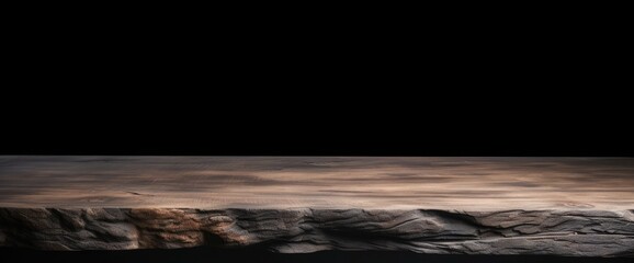 empty wooden oak tabletop with dark black cement stone background for product displayed in rustic mood and tone