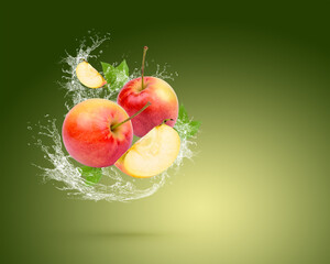 Poster - Water splash on fresh red apple with leaves isolated on green background