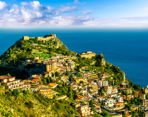 Wall Mural - scenic view at beautiful mountain town on a sea coast in Italy with green hills, antique buildings and amazing blue sea on backgeound of landscape