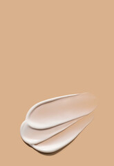 Wall Mural - creamy smear of white cosmetic texture on beige background skin care concept