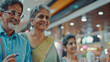 © Neha - Indian senior couple using credit card at shopping mall