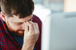 © NonVig/peopleimages.com - Business man, headache and stress in office with fatigue for burnout, negative feedback and depression risk. Tired designer, migraine and frustrated for mistake, deadline and fear for deleted project