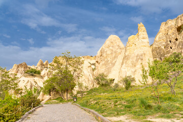 Wall Mural - Türkiye Cappadocia Fairy Chimneys as Peri Bacalari. Volcanic rock landcsape of Fairy tale chimneys in Cappadocia with blue sky on background in Goreme, Nevsehir