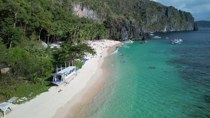 Wall Mural - Aerial footage of tourists at Seven Commandos Beach on a sunny day in El Nido, Philippine