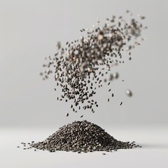 Chia seeds falling on a pile on a white background.