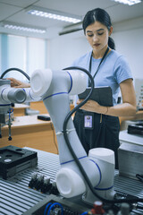 Wall Mural - computer science development engineer working on robotic arm connection control at electronic futuri