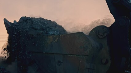 Wall Mural - Close-up of excavator digging up mineral. Stock footage. Cinematic video of industrial mining. Excavator scoops up mountain of mined ore at quarry