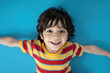 © Neha - happy and black hair Boy stripes red and yellow T-shirt, blue background