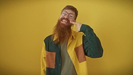 Sticker - Cheerful young redhead man playfully pointing finger to nose, flaunting flawless skincare over yellow background