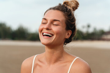 Sticker - Close-Up of a Laughing Woman on the Beach